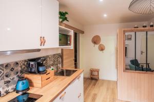 a kitchen with a sink and a counter top at Bulles & Spa Hypercentre Orléans in Orléans