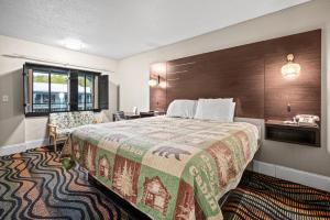 a hotel room with a large bed and a window at Country Town N' Suites in Gatlinburg +95 photos