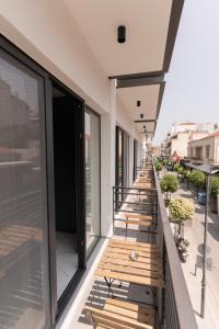 a row of benches on the balcony of a building at Δ17 Suites & Apartments in Larisa