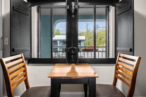 a table and two chairs in front of a window at Country Town N' Suites in Gatlinburg