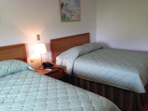 Cama o camas de una habitación en Hotel Brandts Los Robles de San Juan