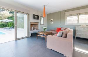 a living room with a couch and a table at Arenaria L. Villas Complex in Lefkada Town