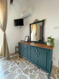 a blue dresser with a mirror on top of it at Le Gorgoni b&b in Syracuse