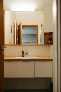 a bathroom with a sink and a mirror at Vík Apartments in Vík