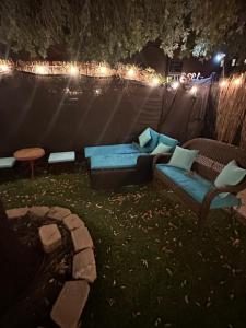 a backyard with a couch and a table and lights at The Hanger in Houston