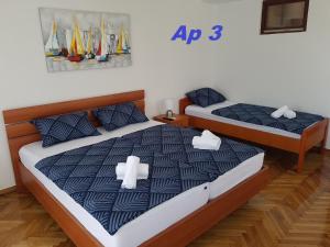 two beds in a room with boats on the wall at Poreč old town, apartments in Poreč