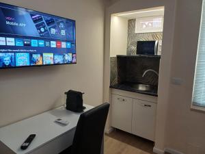 a room with a table and a tv on the wall at Suite 23 in Conversano