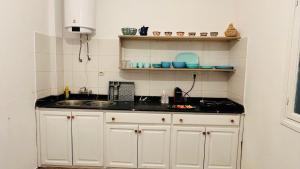 a kitchen with a sink and a counter top at Grand appartement avec rooftop in Monte ʼArrouit