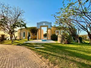 a house with a brick driveway in front of a yard at Hotel Hacienda San Pancho in San Francisco