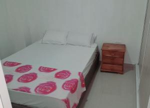 a bedroom with a bed with roses on it at apartahotel Cartagena in Cartagena de Indias