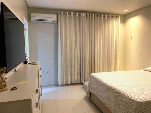 una camera da letto con un letto, un comò e una finestra di Casa bastante agradável e bem localizada! a Petrolina