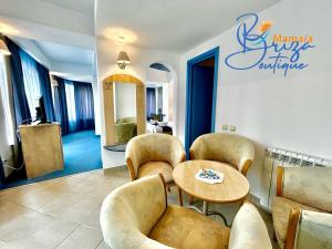 a restaurant with chairs and a table in a room at BRIZA Boutique Hotel Mamaia in Mamaia