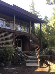 a house with a staircase in front of it at Forest Sweet Retreat Hot Tub & Wood Fired Sauna in Ucluelet
