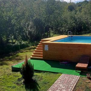 a swimming pool in a wooden building with aitatingfficient at Котедж з власною фінською сауною in Poltava