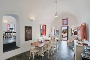 a kitchen and dining room with a table and chairs at PORI HOUSE-VOLCANO VIEW in Oia