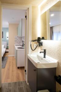 a bathroom with a sink and a kitchen at Green sophia suite in Istanbul