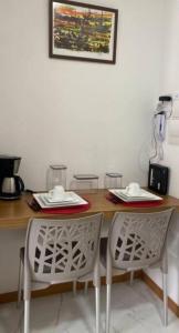 a table and two chairs in a kitchen at Barra, compacto, novo e aconchegante in Salvador +10 photos