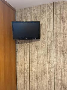 a flat screen tv on top of a wall at Chambre proche de la citadelle in Montmédy +8 photos