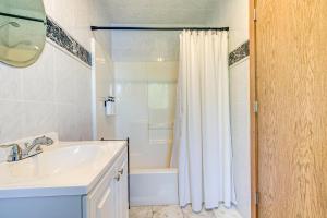 a bathroom with a sink and a shower curtain at Lakefront Wisconsin Getaway Fish, Boat, Relax! in Birnamwood +31 photos