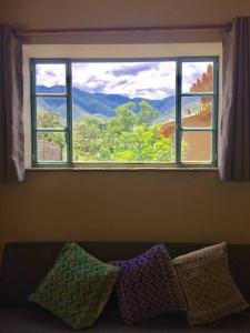 a window with a view of a mountain at El Pocito Quiet Bungalow in Oaxaca City +10 photos