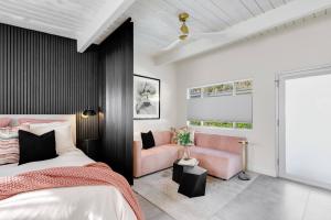 a bedroom with a bed and a couch at Condo 606 W Arenas Rd Unit 2 Palm Springs in Palm Springs +24 photos
