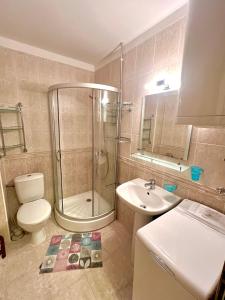 a bathroom with a shower and a toilet and a sink at Vista Residence Apartments in Sveti Vlas