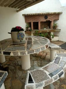 une table en pierre avec une plante en pot sur une terrasse dans l'établissement Casa Pancha, à Ribadeo