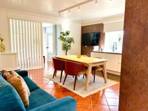 a living room with a table and a blue couch at Solar Do Douro in Santa Cruz do Douro
