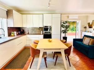 a kitchen and living room with a table and a couch at Solar Do Douro in Santa Cruz do Douro