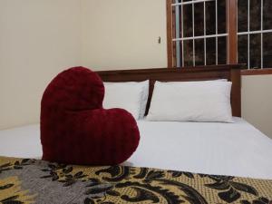 ein Herzkissen auf dem Bett in der Unterkunft Sun Rest Colombo in Colombo