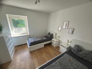 a bedroom with two beds and a window at Altstadt Hemsbach in Hemsbach