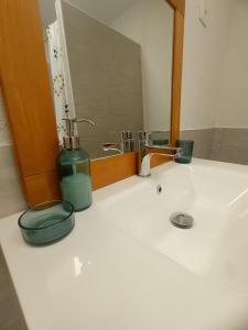 a bathroom counter with a sink and a mirror at Apartment Nada in Izola