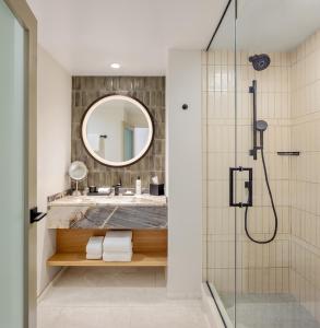 a bathroom with a shower and a sink at Hyatt Regency Scottsdale Resort and Spa in Scottsdale