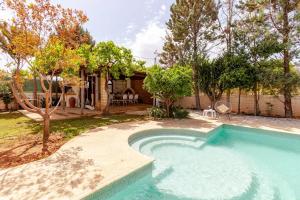 a swimming pool in a yard with a house at Riviera Paradiso in Aghia Marina