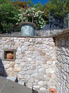 a stone wall with a fountain on top of it at orminia house upper level 