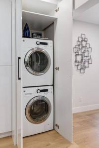 a laundry room with a washer and dryer at Pet Friendly & Accessible, 4 Beds in Calgary