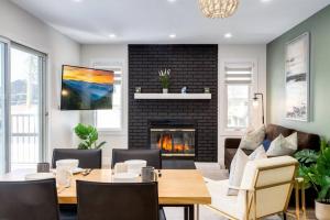 a living room with a table and a fireplace at Pet Friendly & Accessible, 4 Beds in Calgary