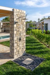 a stone fireplace in the yard of a house at Stone Village Skala Maries in Skala Marion