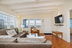 a living room with a couch and a table at Smart Pelican by Oak Island Accommodations in Oak Island