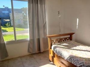 a bedroom with a bed and a large window at El Paraíso en Los Cardales in Los Cardales +25 photos