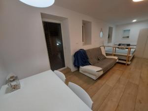 uma sala de estar com um sofá e uma mesa em Casa Orange em Koper
