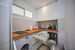 a kitchen with a washer and dryer in it at APARTMENT FLAMINGO in Playa del Ingles