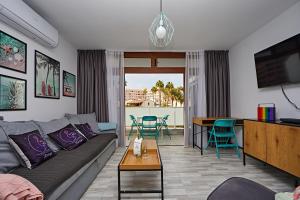 a living room with a couch and a table at APARTMENT FLAMINGO in Playa del Ingles
