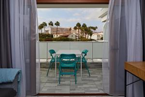 a patio with a table and chairs on a balcony at APARTMENT FLAMINGO in Playa del Ingles