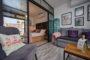 a living room with a couch and a bed at APARTMENT FLAMINGO in Playa del Ingles +17 photos