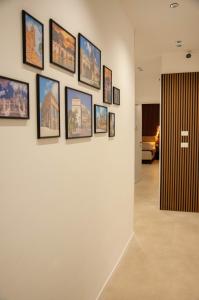 a wall with framed pictures on a wall at Sicily Luxury Rooms in Palermo