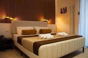 a bedroom with a large bed with towels on it at Sicily Luxury Rooms in Palermo