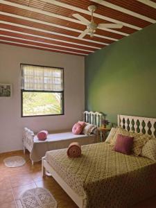 a living room with a bed and a window at Hospedaria Nova Era in Rio Novo