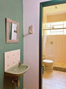 a bathroom with a sink and a toilet at Hospedaria Nova Era in Rio Novo