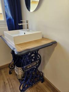 a bathroom sink sitting on a table in a room at Le St Antoine - Centre Ville - Parking in Belfort +40 photos